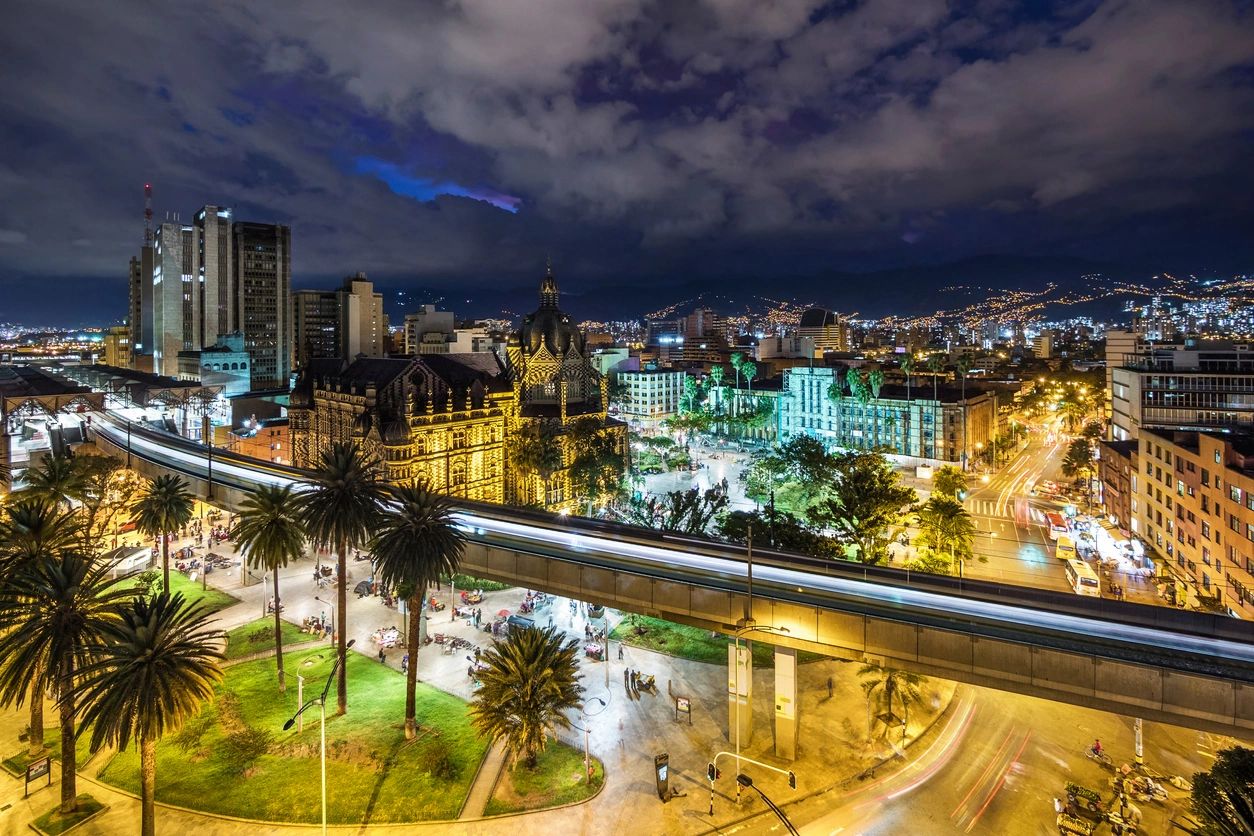 A city at night with lights and trees